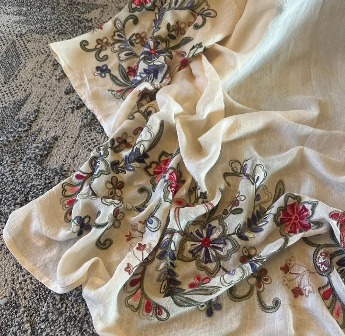 Embroidered fabric with floral patterns on a textured surface