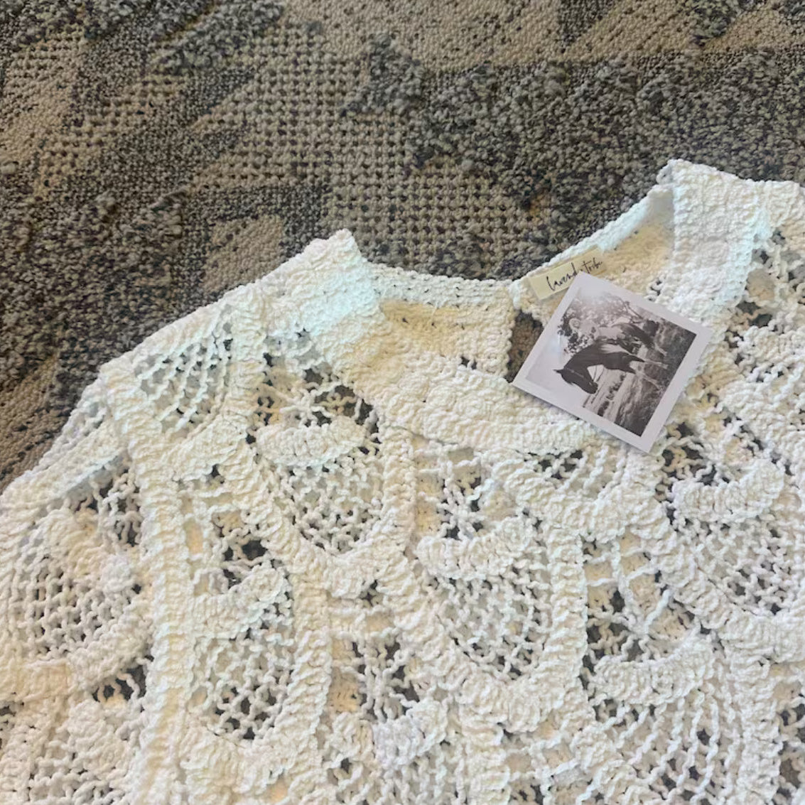 Knitted garment with a tag on a textured surface