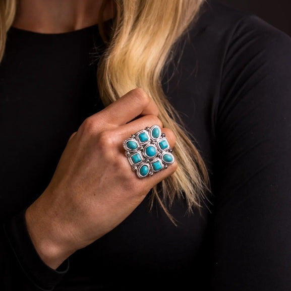 Blonde model wearing turquoise ring