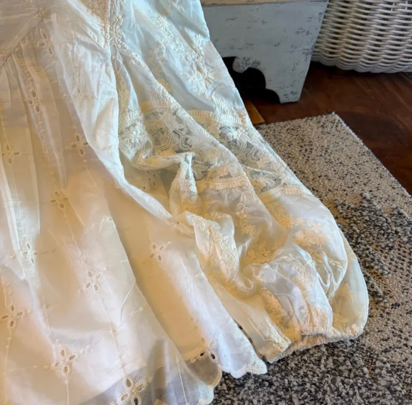 White lace dress on a textured surface with a blurred background