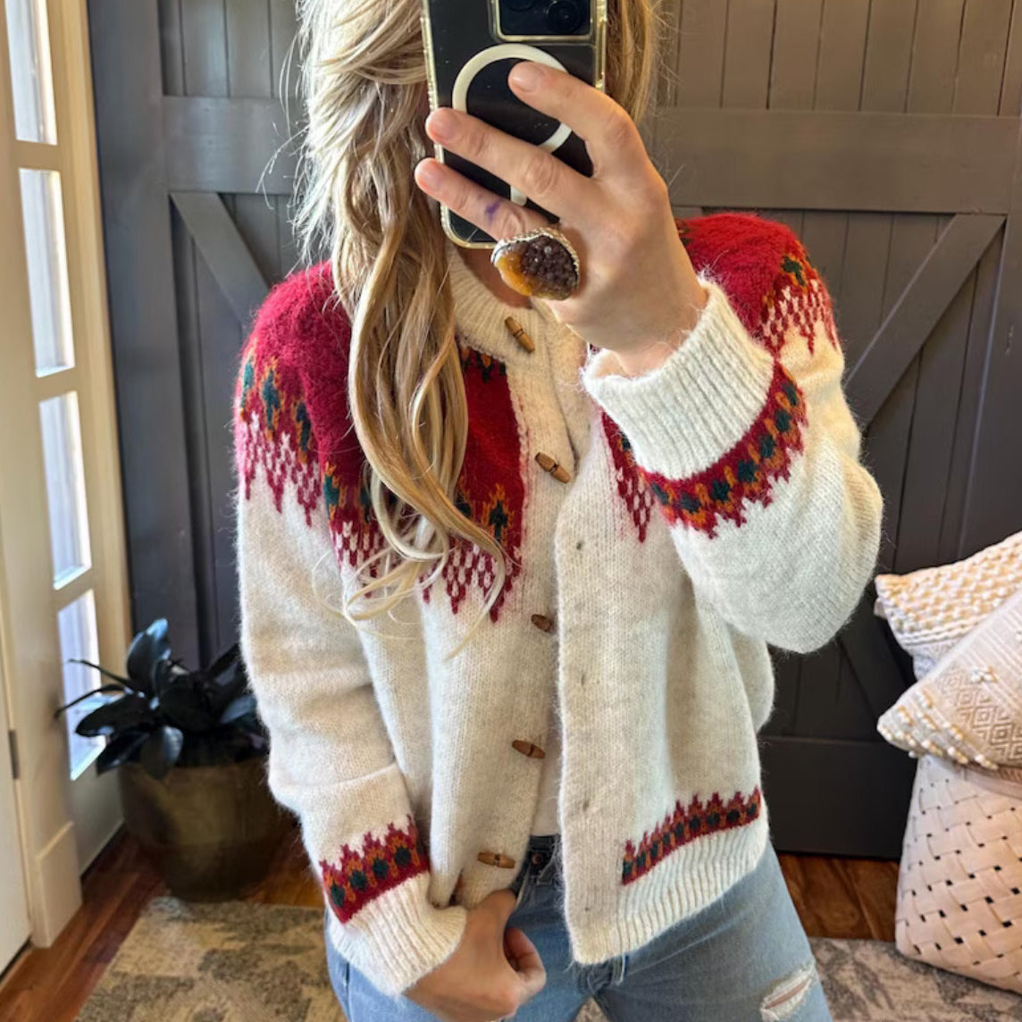 Person wearing a patterned cardigan in a home setting