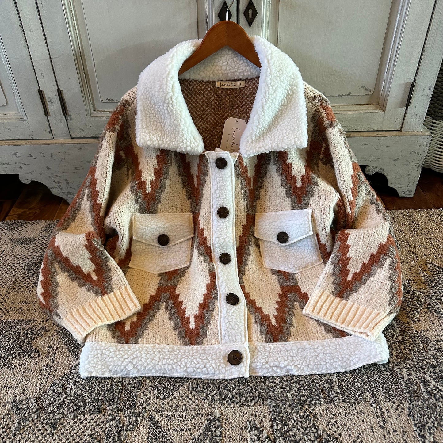 Patterned jacket with white collar and buttons on a textured surface