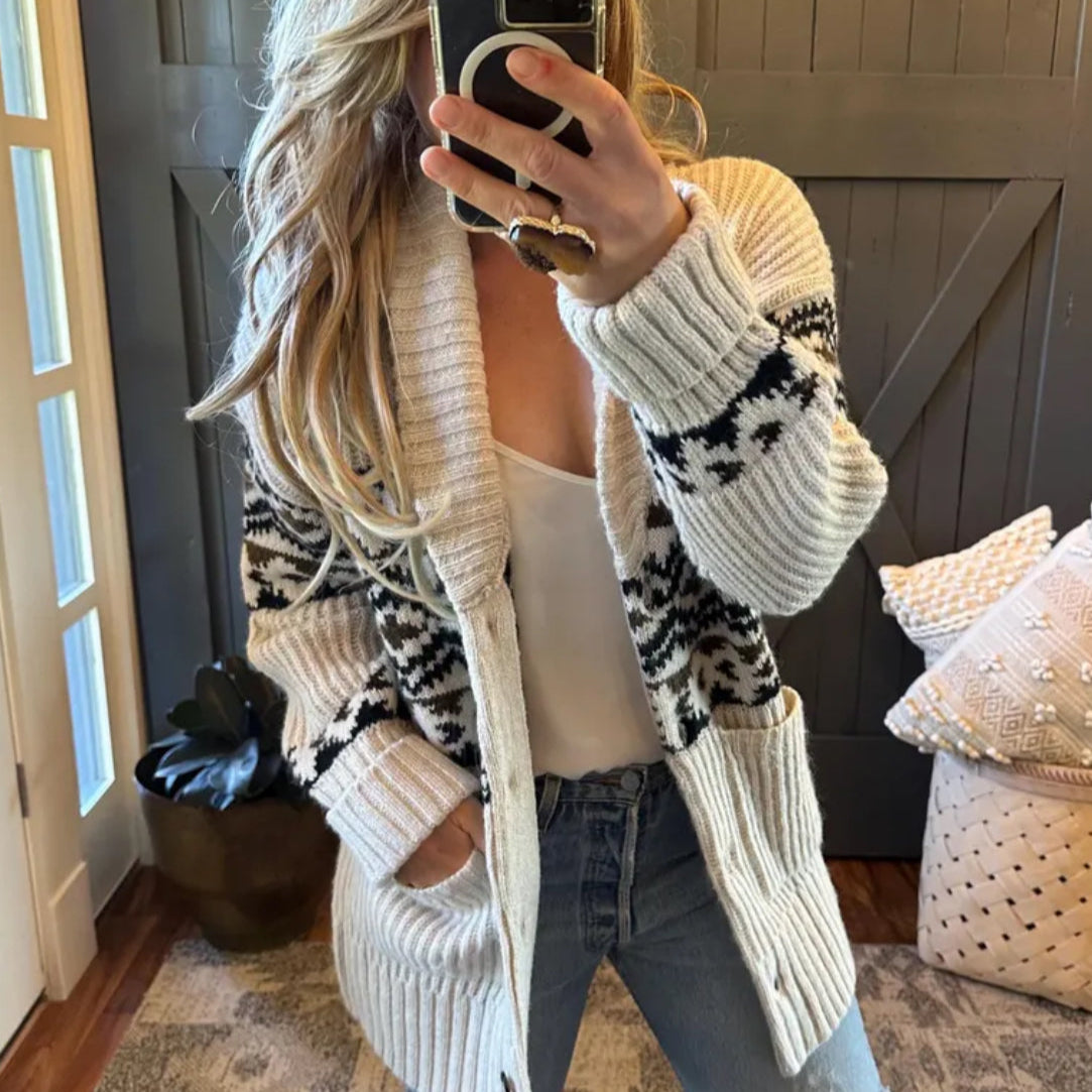 Person wearing a patterned cardigan in a home setting