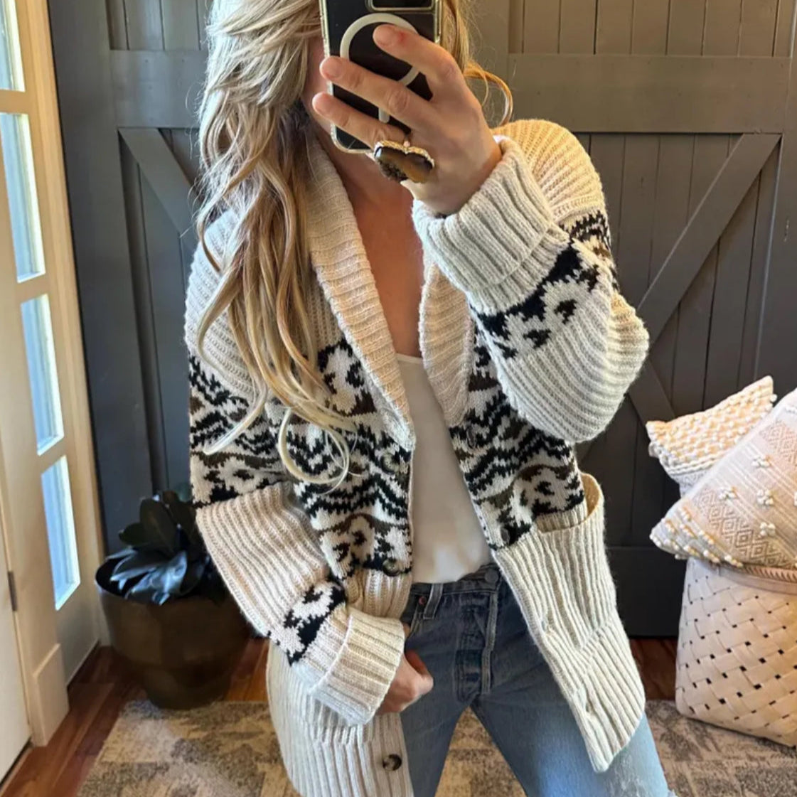 Person wearing a patterned cardigan in a home setting