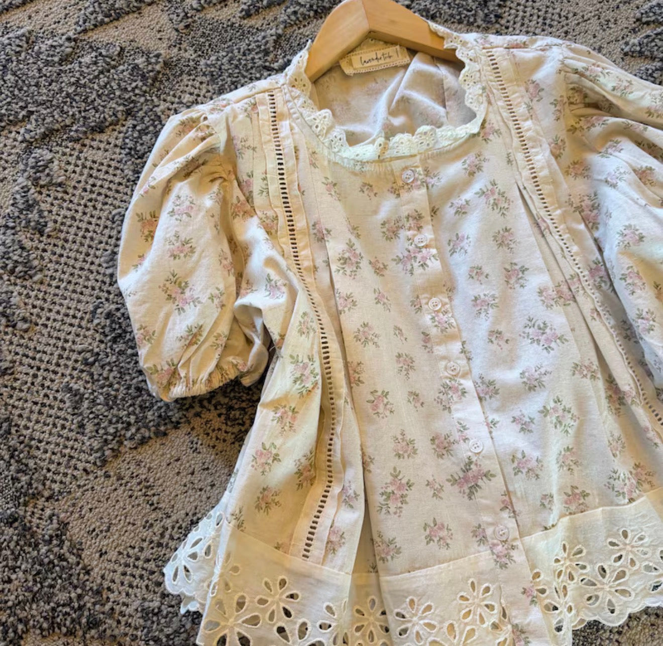 Floral lace blouse on a textured surface