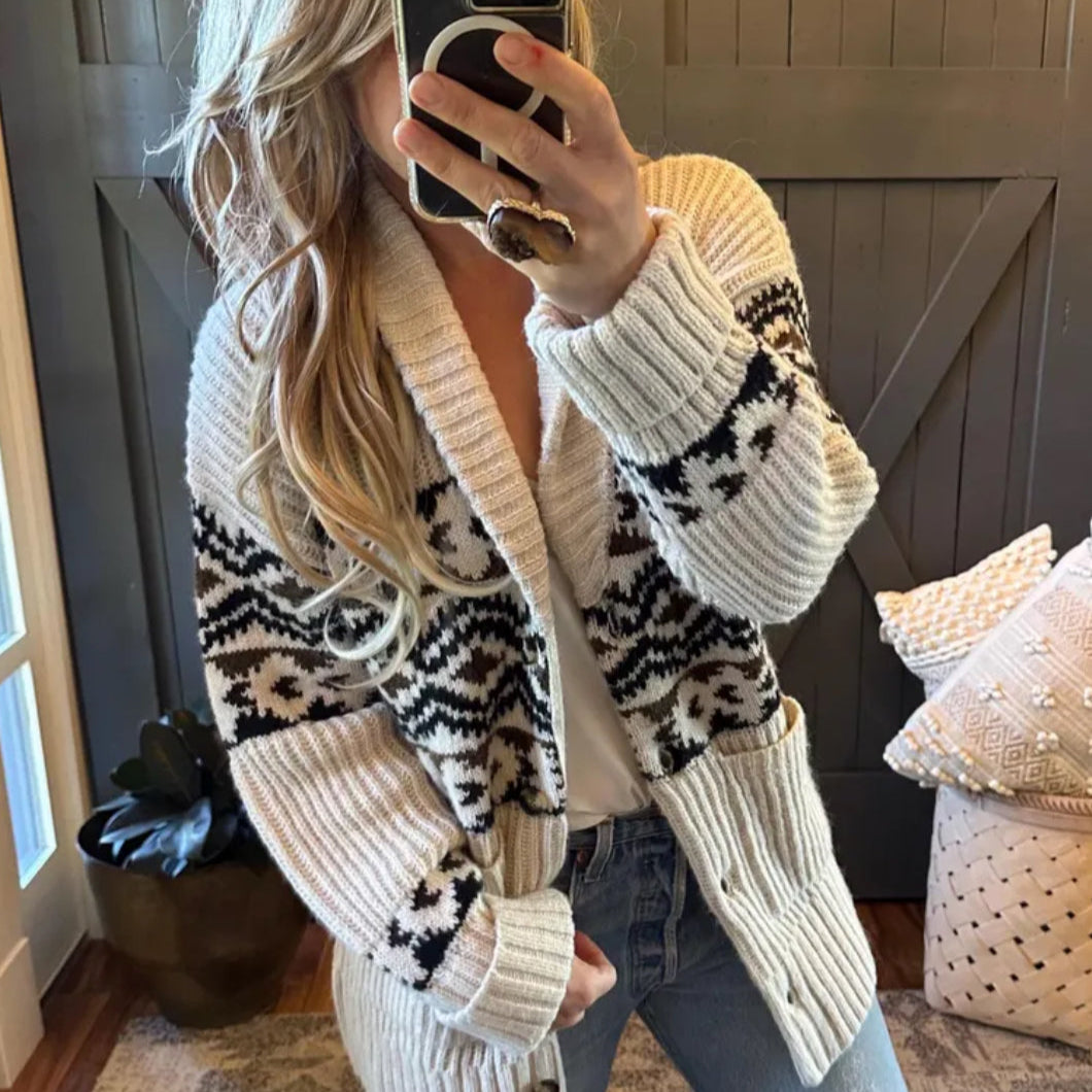 Person wearing a patterned cardigan in a home setting