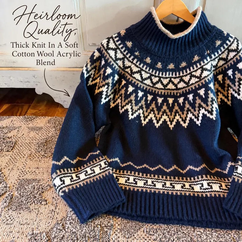 A navy blue knit sweater with a cream and beige Fair Isle pattern, hanging on a wooden hanger on a textured rug. Text overlay in the top left reads 'Heirloom Quality.