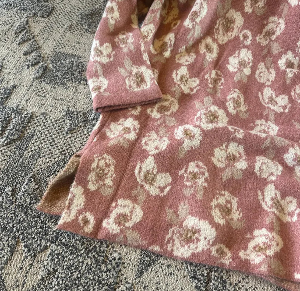 Pink floral-patterned fabric on a textured surface