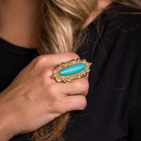 Blond model wearing turquoise and gold ring