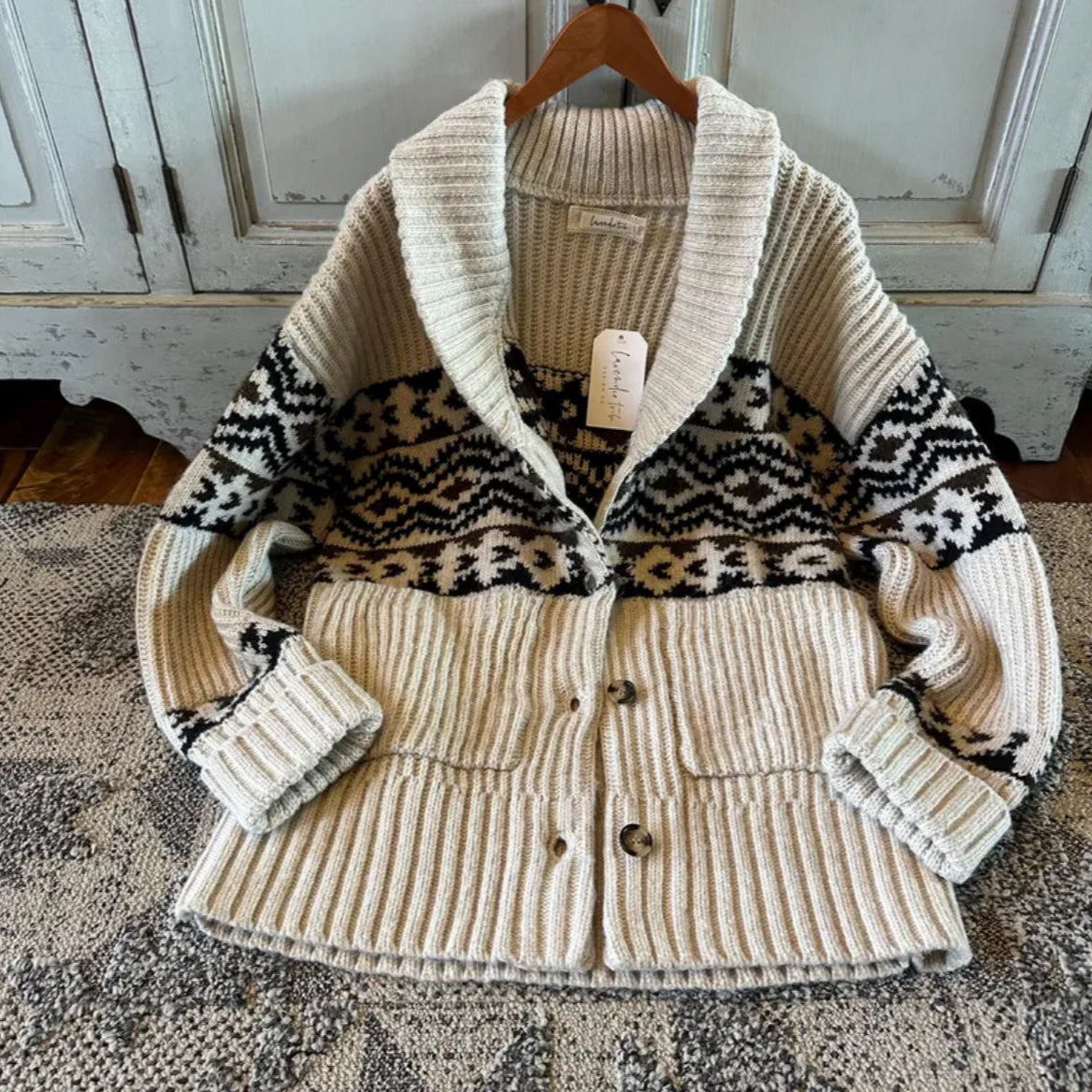Knitted cardigan with patterned collar on a hanger