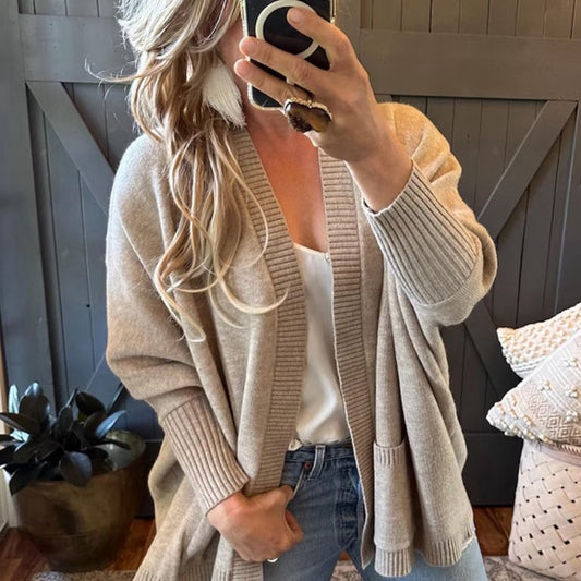 Blond Model Handmade Grey Pocketed Cotton Cardigan Sweater by Lavender Tribe Design. Our Darling Knit Cardigan features an open front, dolman sleeve, pocketed front, soft cotton, and a oversized fit.
+ Soft Grey Thick Knit
+ Dolman Sleeve