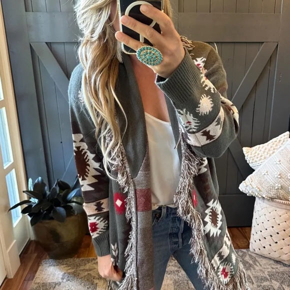 Woman wearing a patterned cardigan in a home setting